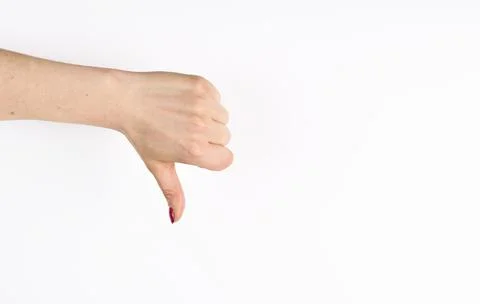 Hand thumb down isolated on white background. No sign by woman. Rejection sym 库存照片