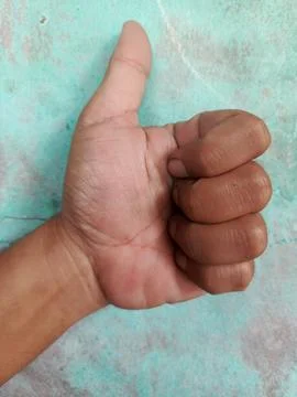 Hand with thumb facing up Stock Photos
