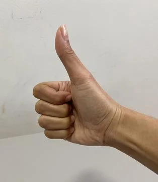 A hand thump up gesture in white background Stock Photos