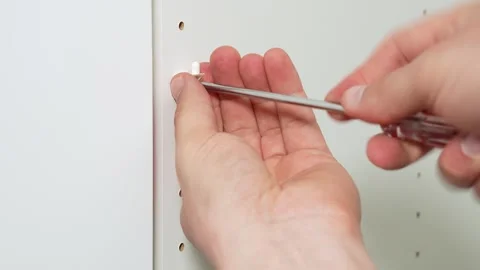 Hand tightening fitting on cabinet panel Stock Footage 334808313