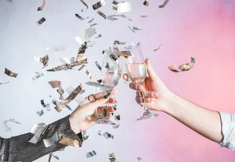 Hand toasting with confetti 스톡 사진