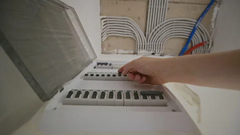 Hand Toggling Circuit Breakers in Home Electrical Panel Stock Footage 340623391