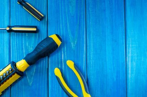 Hand tool on blue wooden background for home work or for locksmith. Stock Photos