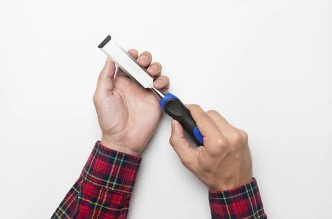 Hand tool chisel on a white background in a man's hand, top view. Craftsman in a Stock Photos