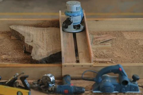 Hand tools and power tools with  slab coffee table. Woodworking and carpentry Stock Photos