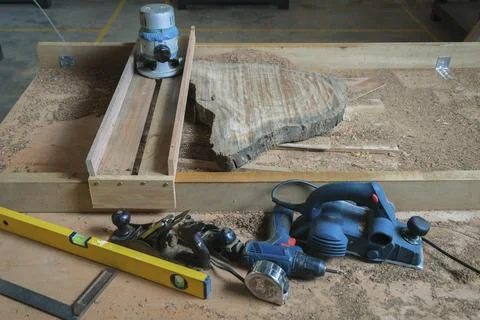 Hand tools and power tools with  slab coffee table. Woodworking and carpentry Stock Photos