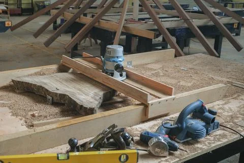 Hand tools and power tools with  slab coffee table. Woodworking and carpentry Stock Photos
