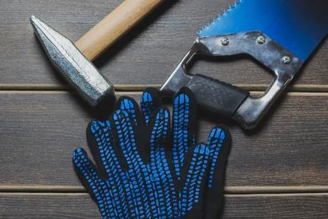 Hand tools and protective gloves on a wooden table.Close-up. Stock Photos