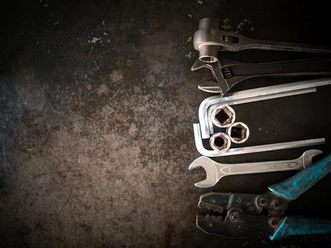 Hand tools consisting of wrenches, pliers, socket wrenches, laid out on old.. Stock Photos
