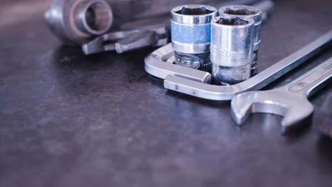 Hand tools consisting of wrenches, pliers, socket wrenches, laid out on old.. Stock Photos