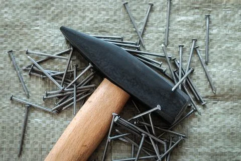 Hand tools, old tools. hammer and nails on a construction surface, close-up Stock Photos