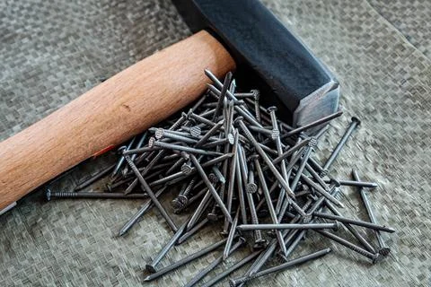 Hand tools, old tools. hammer and nails on a construction surface, close-up Stock Photos