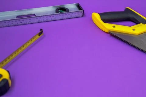 Hand tools ruller, stapler, tape measure hand yellow saw Stock Photos