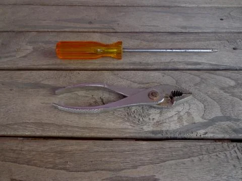 Hand tools Screwdriver with yellow handle and diagonal plier Stock Photos