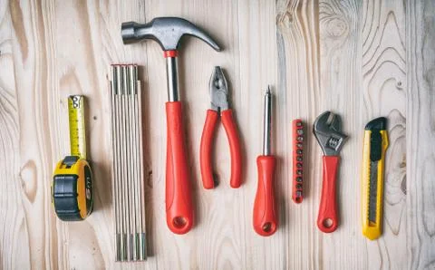 Hand tools set red and yellow color on wood, top view. DIY, repair, service c Stock Photos