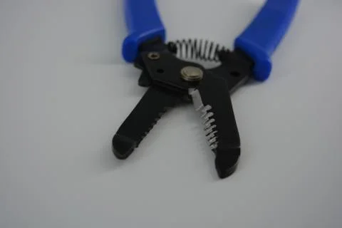 Hand tools for stripping cables and wires, chippers with blue handles. Stock Photos