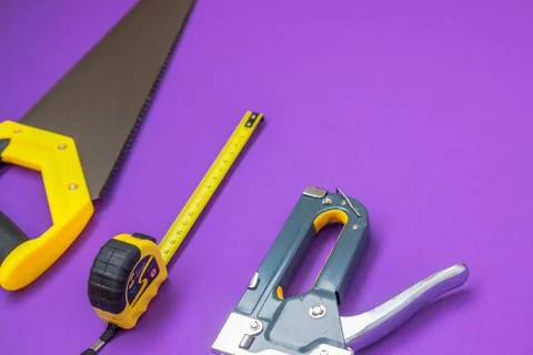 Hand tools yellow ruller, stapler, tape measure hand saw new 2018 work Stock Photos