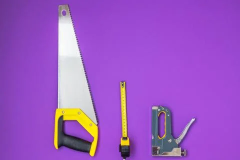 Hand tools yellow ruller, stapler, tape measure hand saw Stock Photos