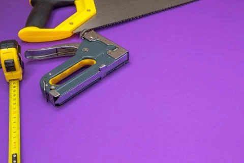 Hand tools yellow ruller, stapler, tape measure hand saw Stock Photos