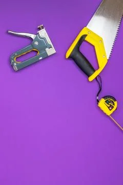 Hand tools yellow ruller, stapler, tape measure hand saw Stock Photos