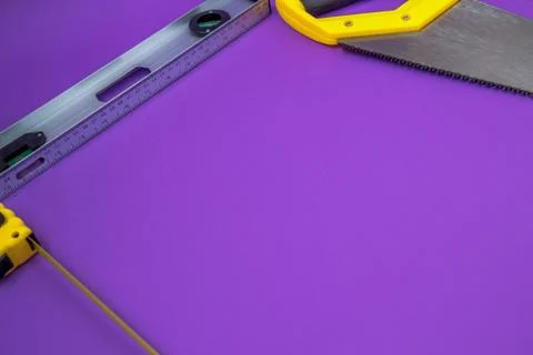 Hand tools yellow ruller, stapler, tape measure hand saw Stock Photos