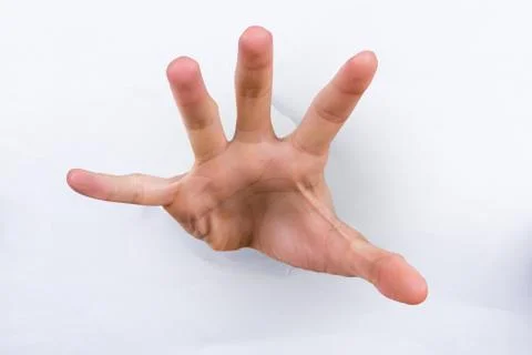 Hand in torn paper Stock Photos
