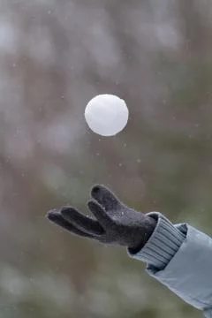 Hand toss up a snowball Stock Photos