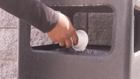 Hand Tossing Used Coffee Cup into Outdoor Trash Bin in Slow Motion Stock-Footage 347586818