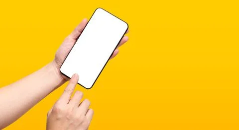 Hand touch mobile screen mockup on yellow background. Clipping path include a Stock Photos