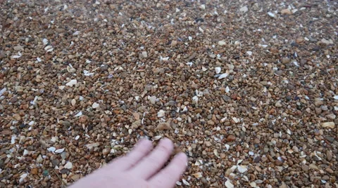 Hand Touch the Pebbles on the Sea Stock Footage 67713598