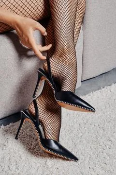 Hand touch strap of high heel shoes Stock Photos