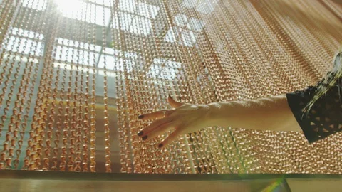 Hand touches a curtain of balls Stock Footage 108551453