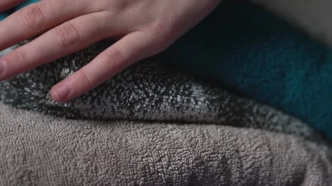 Hand touches stack of colored towels Stock Footage 329467703