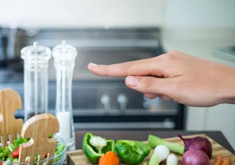 Hand touching air with cooking objects in kitchen Stock Photos