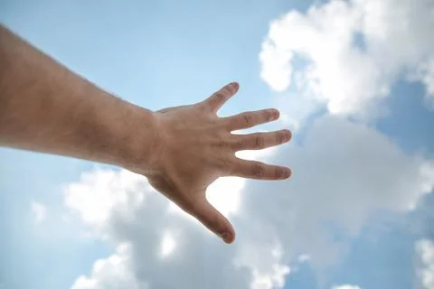 Hand touching the blue sky Foto stock