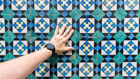 Hand touching ceramic blue patterns tiles from Lisbon, Portugal Stock Photos