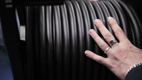 Hand touching coiled stage cable on reel Video stock 308624759