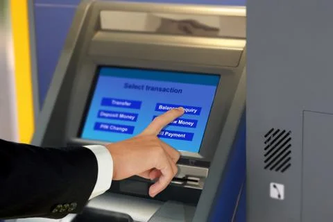 Hand touching display screen at ATM terminal Stock Photos