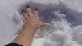 The hand touching the fluffy snow 4k or 4k+ Resolution
