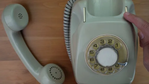 A hand is touching the hang button several times. Off-hook handset. Stock Footage 128372035