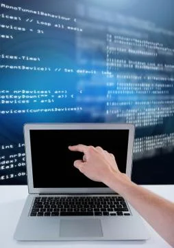 Hand touching laptop with coding text Foto stock