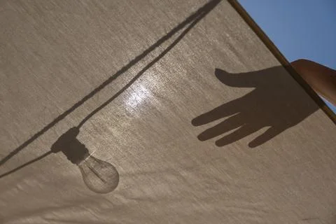 Hand touching light Bulb Stock Photos