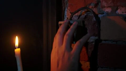 Hand Touching Light Switch Next to Candle Flame Stock Footage 308469417