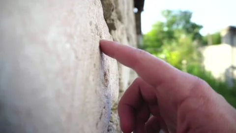 Hand Touching Limestone Block Wall of a House Close Up 動画素材 345979607