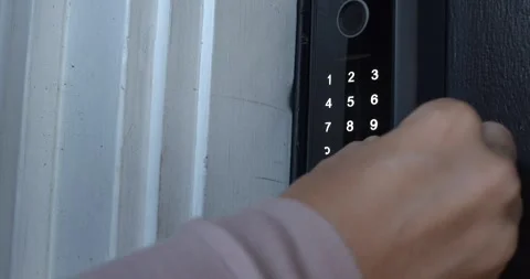 Hand touching the lock icon on Smart Door Lock Keypad for Home Security Stock Footage 340323483
