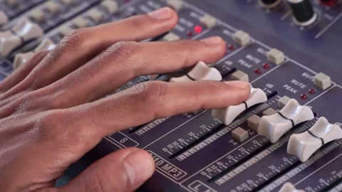 Hand touching mixing console buttons, sound engineering panel, Stock Footage 344011348