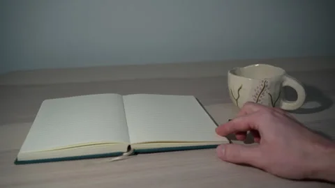 Hand touching notebook page while planning Video stock 327350228