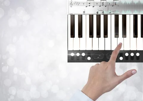Hand Touching Piano keys with notes and effects App Interface Stock Photos