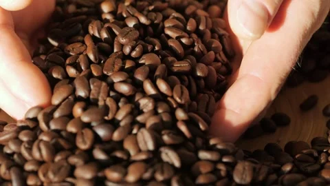 Hand is touching a pile of coffee beans Stock Footage 300525750
