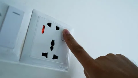 Hand Touching Power Socket on White Wall Stock Footage 317737262